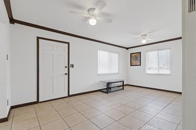 tiled empty room featuring crown molding and ceiling fan