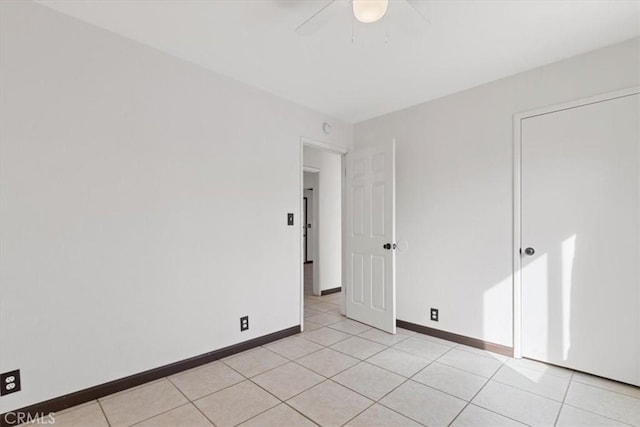 unfurnished bedroom featuring light tile patterned flooring and ceiling fan