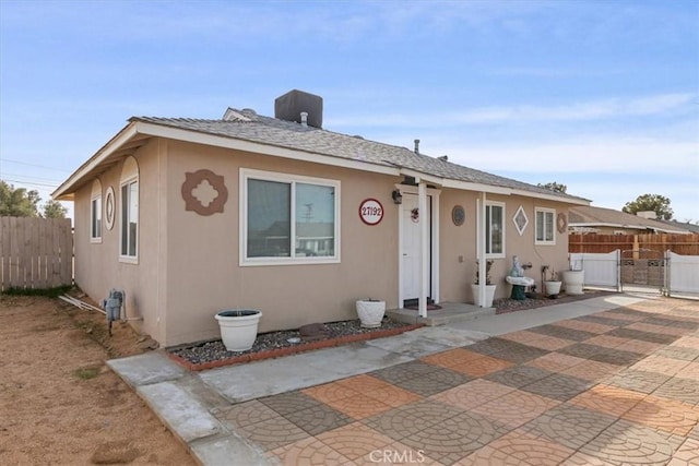 bungalow-style home with a patio area