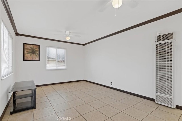 tiled empty room with ceiling fan and ornamental molding