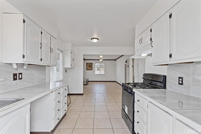 kitchen featuring white cabinetry, backsplash, black range with gas stovetop, and light tile patterned flooring