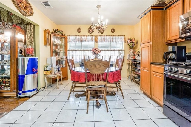 dining area with a notable chandelier and light tile patterned flooring