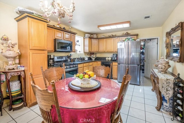 426 Sonora Ave, Glendale, CA 91201 - kitchen featuring stainless steel appliances, a chandelier, and light tile patterned flooring
