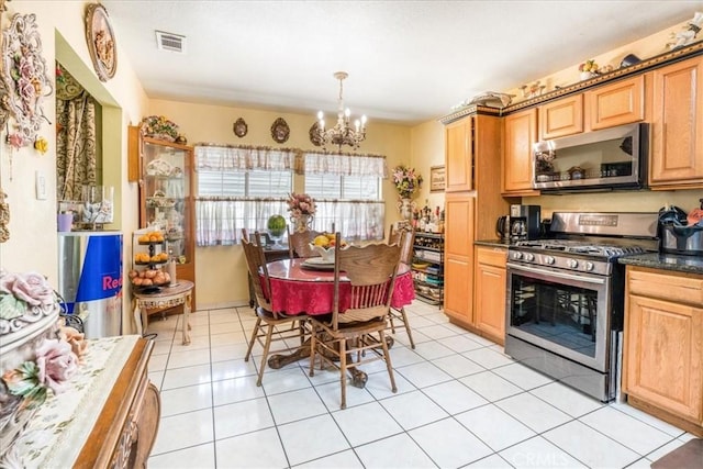 426 Sonora Ave, Glendale, CA 91201 - kitchen with stainless steel appliances, a chandelier, dark countertops, light tile patterned floors, and light brown cabinets