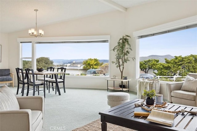 living area featuring vaulted ceiling with beams, a notable chandelier, a mountain view, and carpet flooring