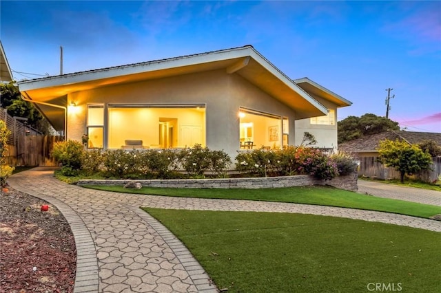 1141 Green Oaks Dr, Los Osos, CA 93402 - back of property at dusk featuring stucco siding