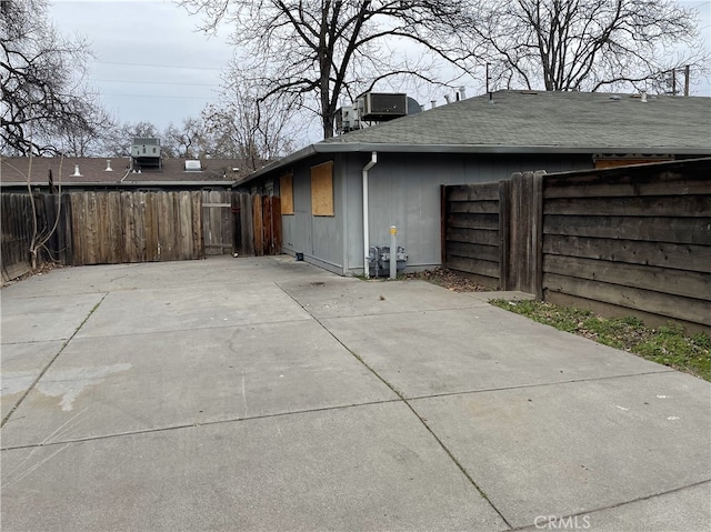 view of side of home featuring central AC unit and a patio area