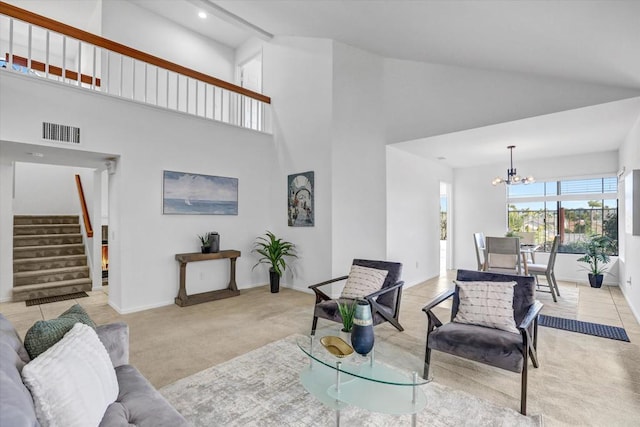 living room featuring high vaulted ceiling, light colored carpet, and an inviting chandelier