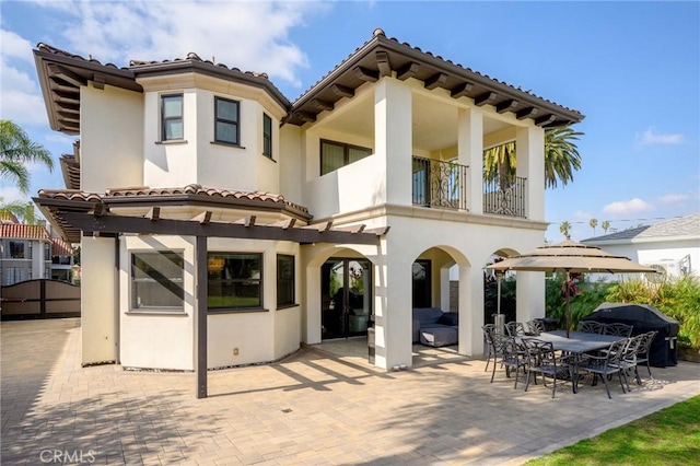 back of property with a patio area and a balcony