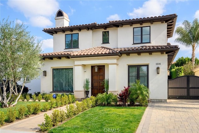 mediterranean / spanish-style house featuring a front lawn