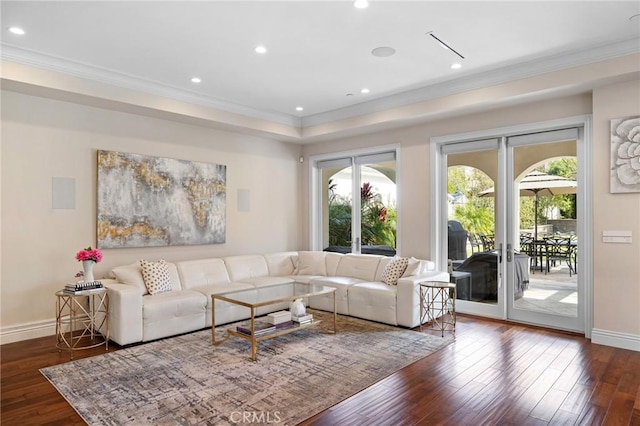 living room featuring dark hardwood / wood-style flooring, plenty of natural light, crown molding, and french doors