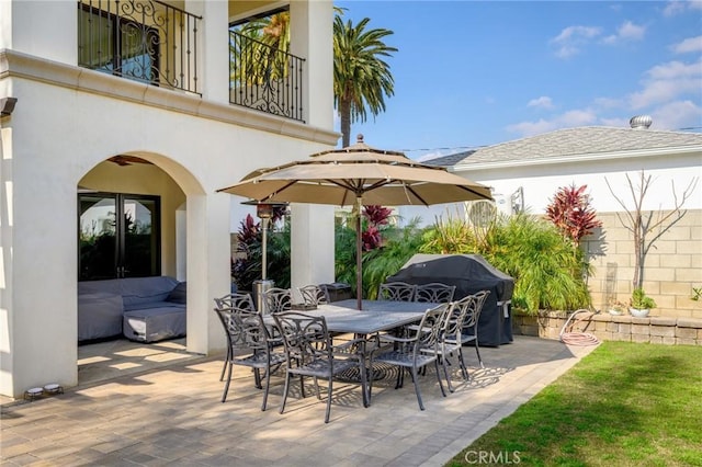 view of patio featuring area for grilling and a balcony