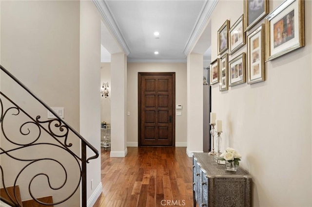 entryway featuring ornamental molding and dark wood-type flooring