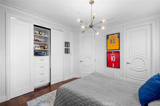 bedroom featuring a chandelier, dark hardwood / wood-style floors, and ornamental molding