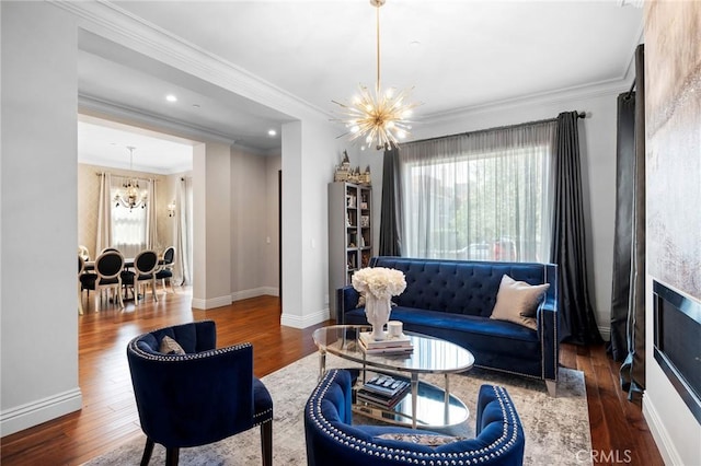 living room with dark hardwood / wood-style floors, crown molding, and an inviting chandelier