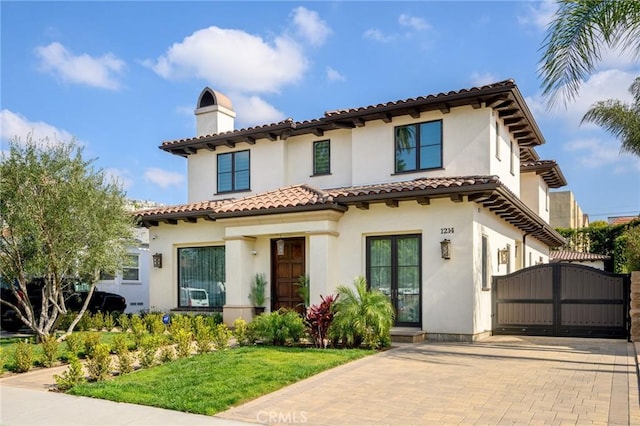 mediterranean / spanish-style house featuring a front lawn