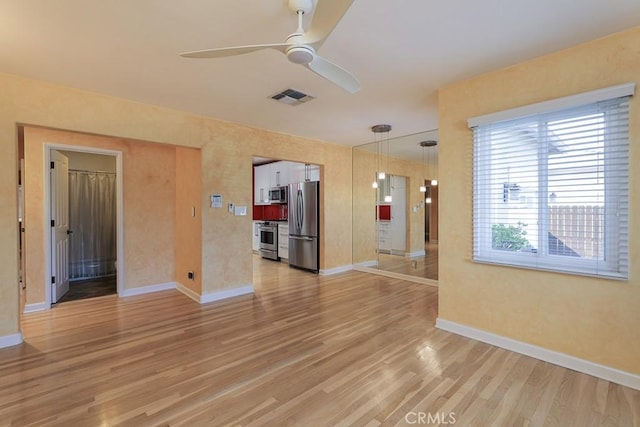 spare room with hardwood / wood-style floors and ceiling fan