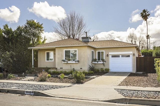 view of front of property featuring a garage and cooling unit