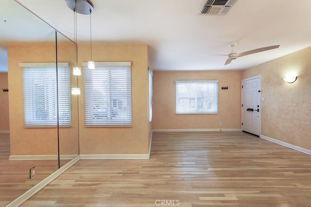 foyer entrance with light wood-type flooring and ceiling fan