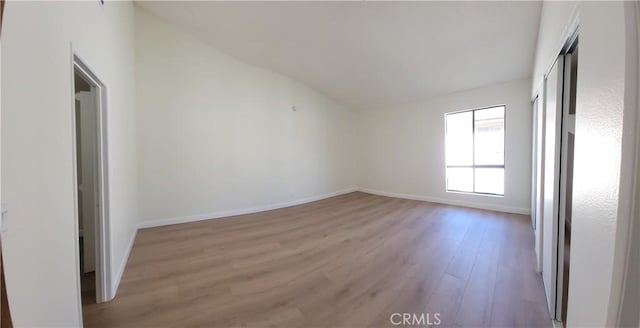 interior space with vaulted ceiling and light hardwood / wood-style floors