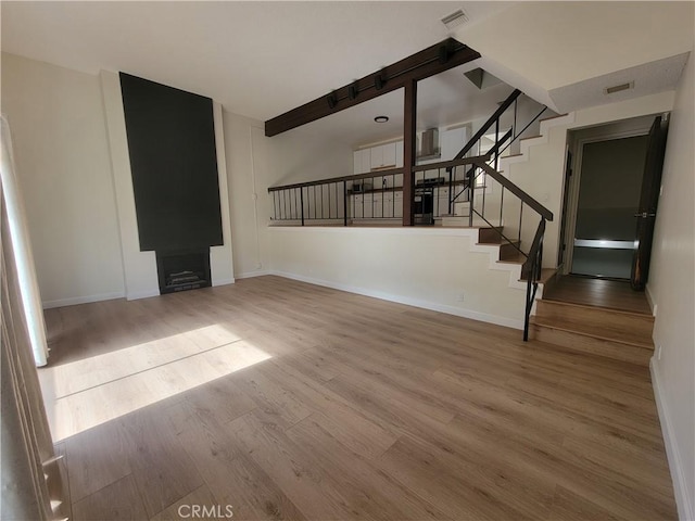 unfurnished living room with hardwood / wood-style floors