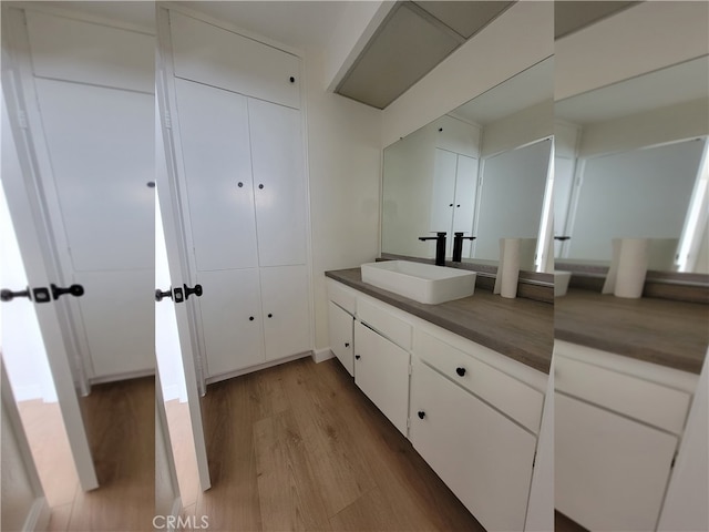 bathroom featuring hardwood / wood-style flooring and vanity