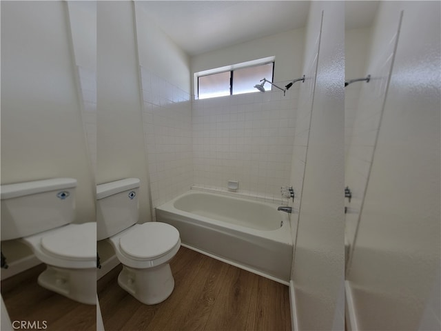 bathroom featuring toilet, hardwood / wood-style floors, and tiled shower / bath