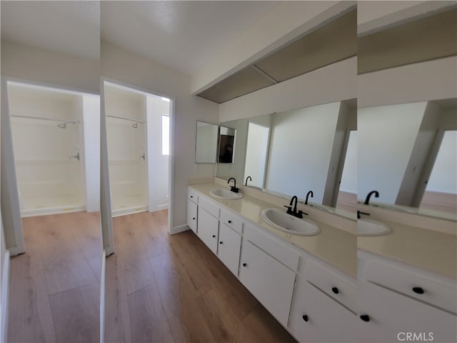 bathroom with vanity, a shower, and hardwood / wood-style floors