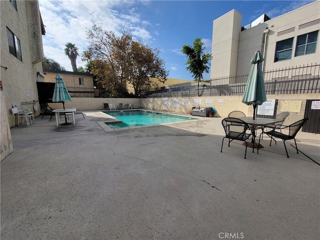 view of swimming pool with a patio