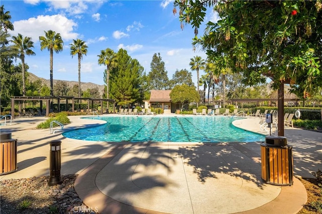 pool featuring a patio area, a mountain view, fence, and a pergola