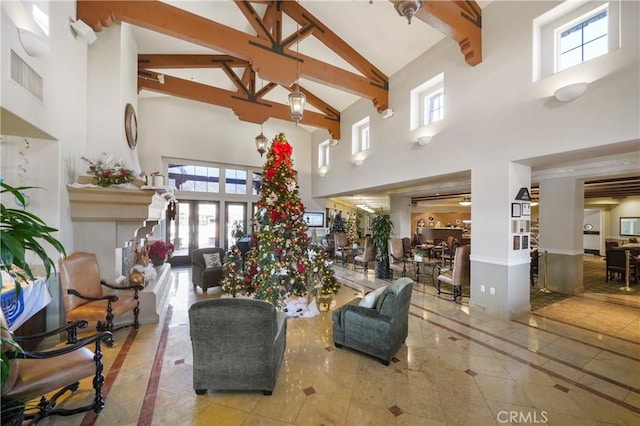 living area with high vaulted ceiling, beam ceiling, and visible vents