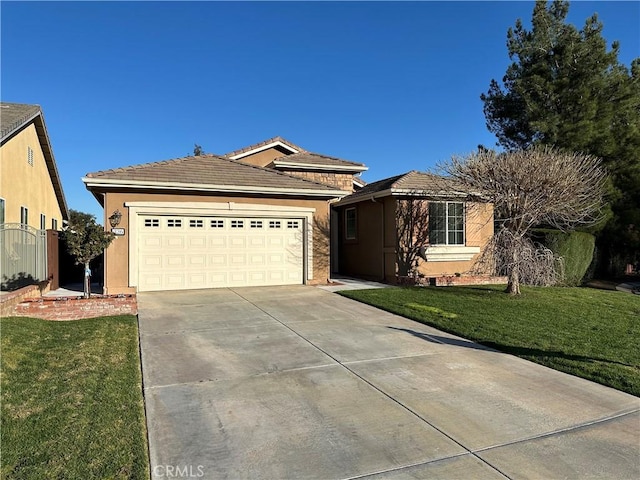 view of front of property with driveway, a garage, a tile roof, a front lawn, and stucco siding