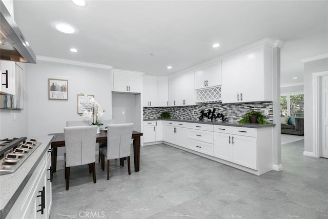 kitchen with white cabinets, gas cooktop, and ventilation hood