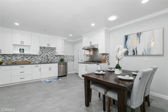 kitchen with ornamental molding, white cabinets, stainless steel appliances, and decorative backsplash