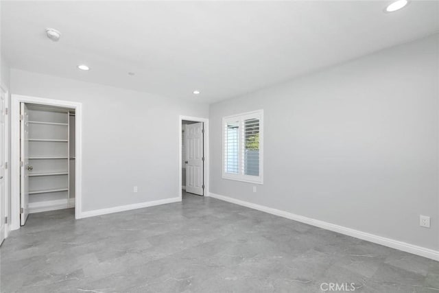 unfurnished bedroom featuring a closet and a walk in closet