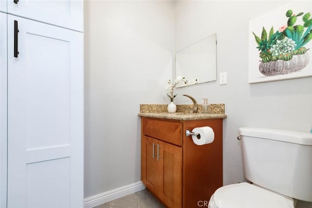 bathroom featuring tile patterned floors, toilet, and vanity