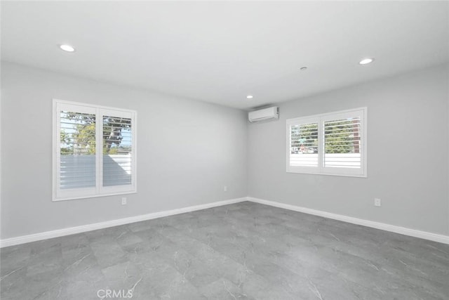 spare room with an AC wall unit