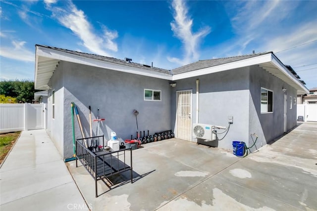 rear view of house with a patio and ac unit