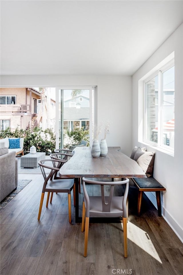 dining area with breakfast area and dark hardwood / wood-style flooring