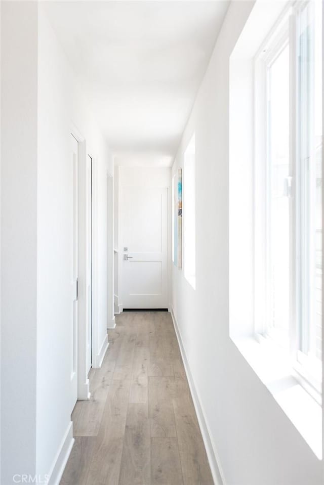 hall with light hardwood / wood-style floors