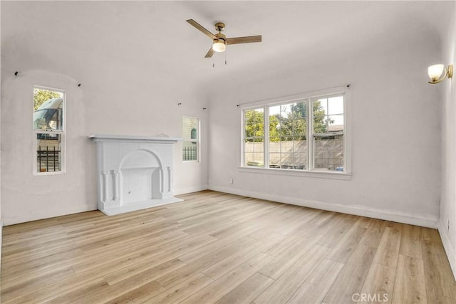 3438 Mckinley Ave, Los Angeles, CA 90011 - unfurnished living room featuring wood finished floors, a fireplace, a ceiling fan, and baseboards