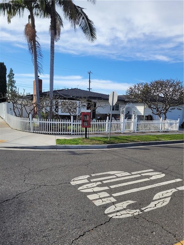 view of street featuring curbs, traffic signs, and sidewalks