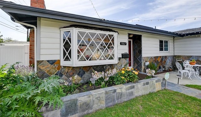 3067 Trinity Dr, Costa Mesa, CA 92626 - view of front of house featuring a chimney and fence