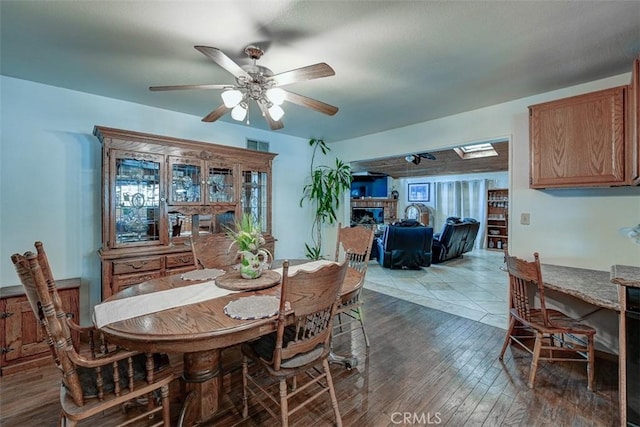 3067 Trinity Dr, Costa Mesa, CA 92626 - dining room featuring a ceiling fan, a glass covered fireplace, hardwood / wood-style floors, and visible vents