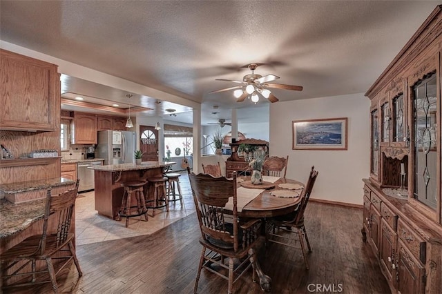 3067 Trinity Dr, Costa Mesa, CA 92626 - dining area with wood finished floors, a textured ceiling, baseboards, and ceiling fan