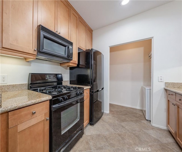 kitchen with recessed lighting, baseboards, light stone countertops, black appliances, and washer / clothes dryer