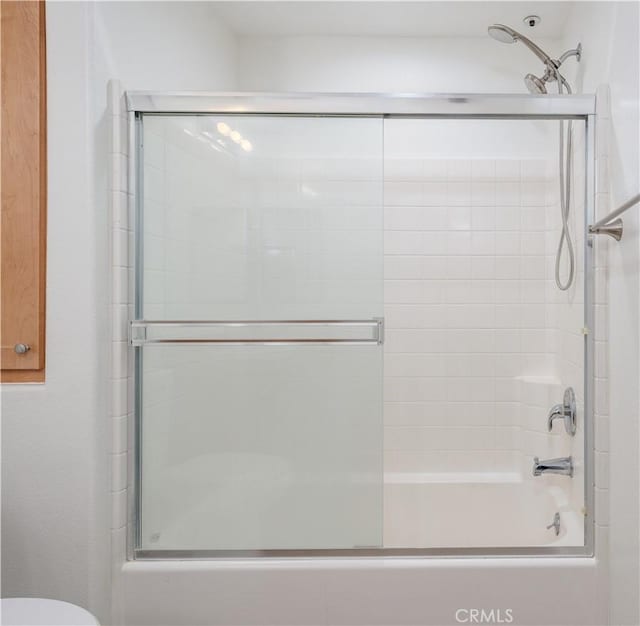 full bath featuring enclosed tub / shower combo and toilet