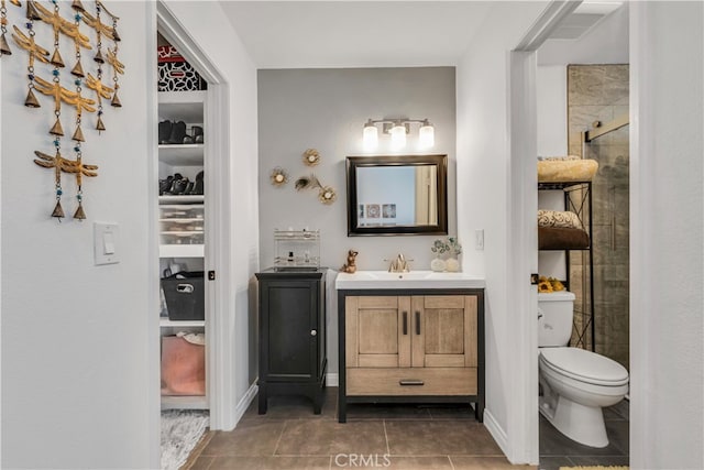 bathroom featuring an enclosed shower, vanity, toilet, and tile patterned floors