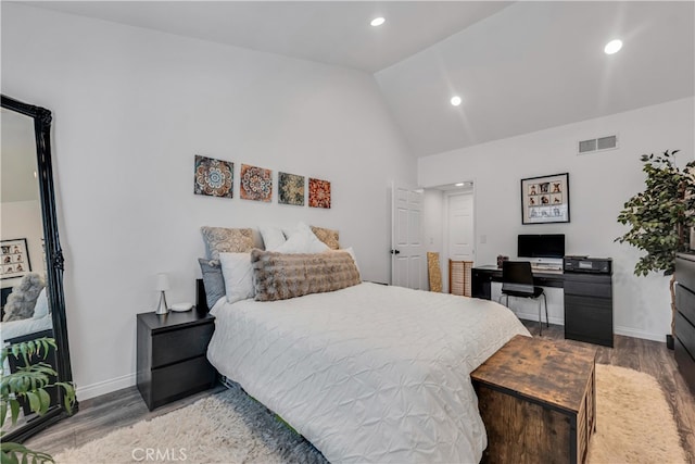 bedroom featuring wood-type flooring and lofted ceiling