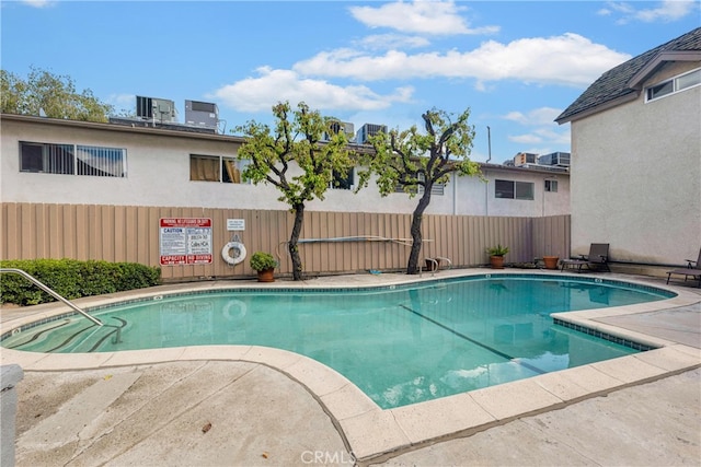 view of swimming pool featuring central AC unit